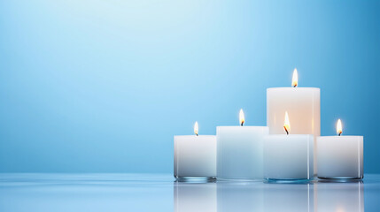 Four white pillar candles of different heights, aligned in a row on a modern glass surface - Powered by Adobe