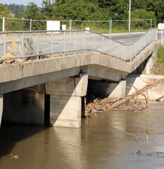 Collapsed broken road bridge after the flood