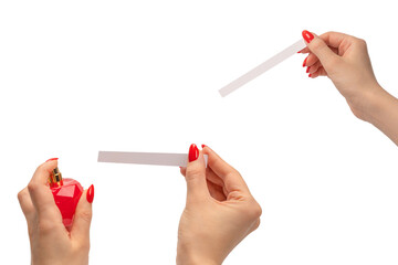 Woman hand with red nails with test strips for the perfume, isolated on a white background.