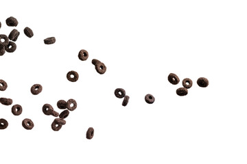 Chocolate rings cereal spill out into a bowl. Breakfast.