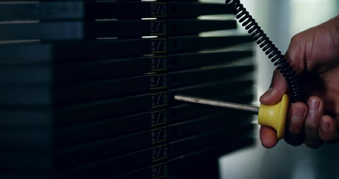 Hand, weight machine and pin in gym for workout, training and healthcare with safety, choice and goal. Person, exercise and metal equipment for bodybuilding, challenge and strong muscle for fitness