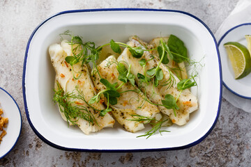 Baked white fish filet with green pea and lime