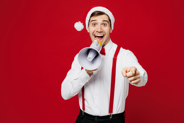 Merry young fun man wear white shirt Santa hat posing hold megaphone scream announces sale Hurry up...