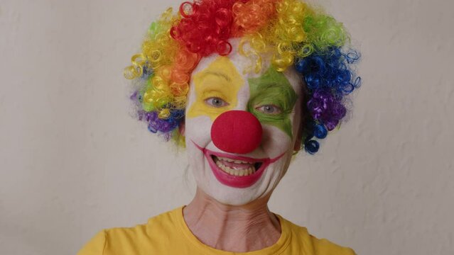 Portrait of funny clown making people laugh by grimacing face.