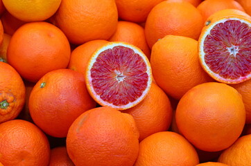 background of ripe orange oranges and some cut in half for sale