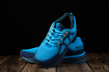 Light blue running shoes on a dark background.