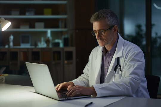 Doctor working with his laptop in a hospital office. Medical concept, health.
