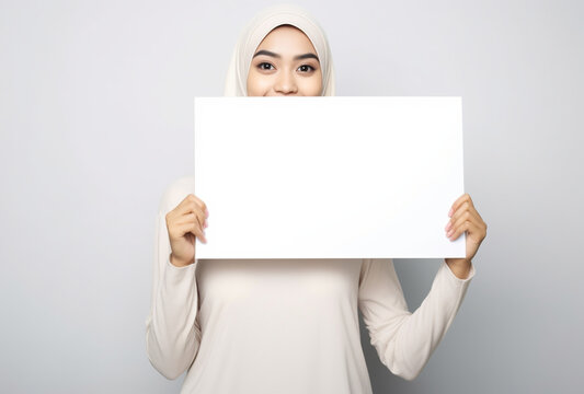 a beautiful Indonesian woman holds a blank placard sign in her hand. isolated on white background, Ai generated Images