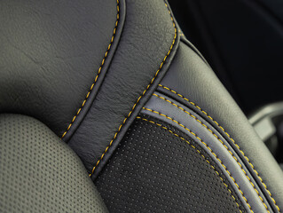 Part of leather car headrest seat details. Сlose-up black  perforated leather car seat. Skin texture