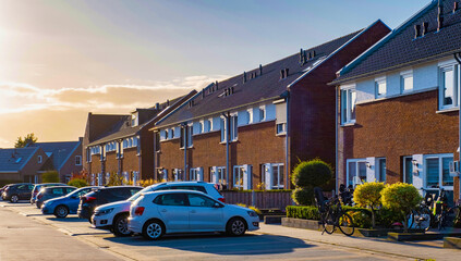 Dutch Suburban area with modern family houses, newly built modern family homes in the Netherlands, dutch family houses in the Netherlands, row of newly built houses in the Netherlands at sunset - obrazy, fototapety, plakaty