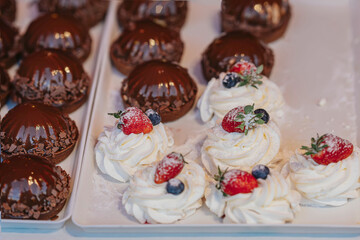 Types of cakes close-up. Assortment of chocolate and fruit cakes, patisserie counter