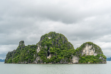 Fototapeta na wymiar The limestone rocks of Ha Long Bay as seen from a small cruise boat