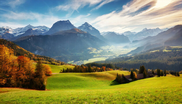 scenic image of swiss alps panoramic view of idyllic mountain scenery in the alps with fresh green meadows on a beautiful sunny day in autumn grassy field and rolling hills rural scenery