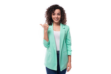 Obraz premium pretty smiling young brunette curly businesswoman dressed in a blue jacket