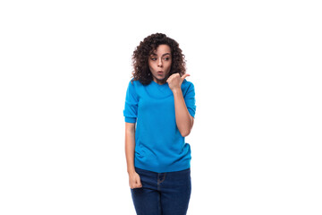 young upset woman with curls dressed in a blue t-shirt is annoyed