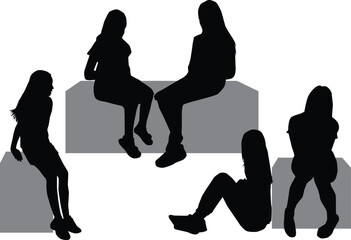 Black silhouettes of peopley sitting on a bench.