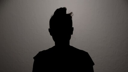 Hidden identity silhouette of woman talking anonymous interview looking at camera.