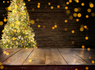 An empty wooden table. Wooden surface on the background of a decorated Christmas tree. Festive, New...