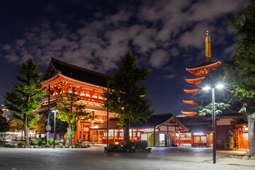 Sensoji Temple in nighttime, symbolized by large red lanterns and 5-story pagoda with light, are a...