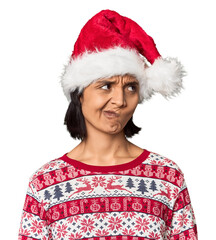 Young Hispanic in Christmas attire with hat being shocked, she has remembered important meeting.