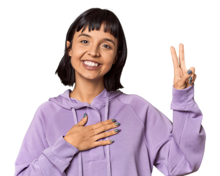 Young Hispanic woman with short black hair in studio taking an oath, putting hand on chest.