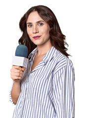 Young Caucasian journalist with microphone in studio setting