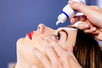 Cropped shot of a woman dripping her eyes with medicinal drops natural tear. Disease of eye retina....