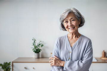 Old woman smiling in living room, look at the camera, copy space