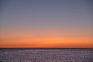 Naklejka na ściany i meble Background with sea on the sunset and Venus star, space for text