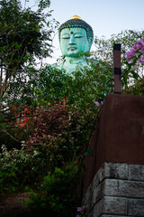 Vertical view of big Seated Buddha Statue in the morning on the top of mountain at Wat Phra That...