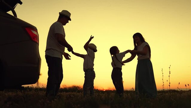 Family Dad mom child daughter son, children dance in beautiful sunset. Parents children stopped at campsite by car. Family travels by car. Family holiday in nature. Travel, car. Kid. Complete family