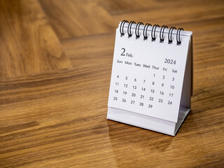 A February 2024 on calendar desk for the organizer to plan and reminder on wood background with...