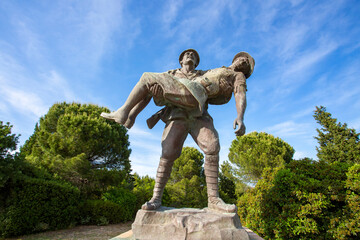 Canakkale / Turkey, May 26, 2019 / Monument of a Turkish soldier carrying wounded Anzac soldier at Canakkale (Dardanelles) Martyrs' Memorial, Turkey. - obrazy, fototapety, plakaty