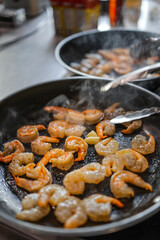 peeled shrimp fried in a frying pan - 684229402
