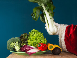 Santa Claus holds fresh bok choy in his hand.  Healthy lifestyle en new year's resolutions concept.