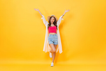 Full body portrait of pretty Asian woman wearing summer outfit smiling and raising hands up in...