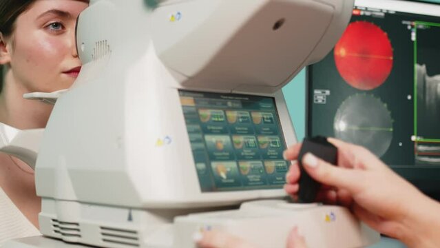 A female ophthalmologist performs a retinal examination using optical coherence tomography (OCT). The concept of medical vision diagnostics or vision correction.