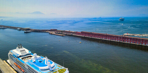 NAPLES, ITALY - JUNE 18, 2021: Aerial view of city port from a drone going up in the sky.