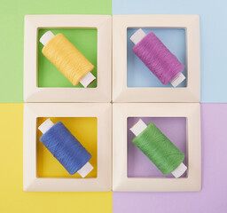 four frames with threads on a multi-colored background