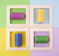four frames with threads on a multi-colored background