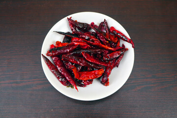 Red chili Peppers are kept in a white container