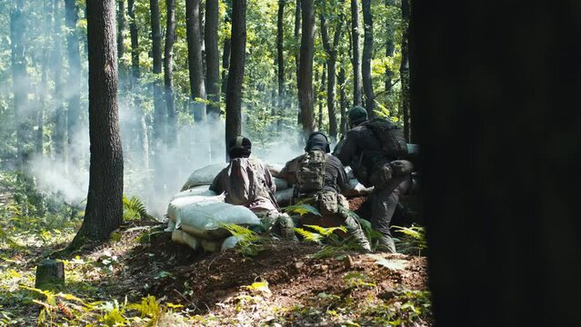 Airsoft Team Waiting Defending the Sandbag Bunker in the Forest