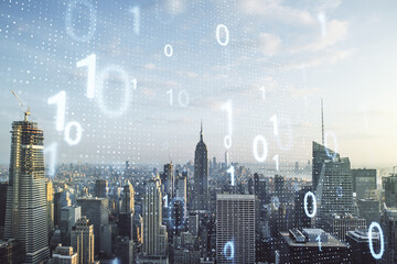 Double exposure of abstract virtual binary code hologram on New York city skyscrapers background. Database and programming concept