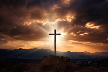 Cross on the rock with dramatic sunset sky background. Christian concept.