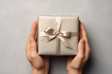 Hands holding a silver gift. Christmas card. AI generative.