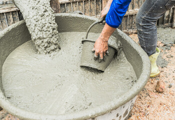 Hand worker scoop bucket concrete