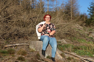 portrait of a middle-aged woman with red hair in the countryside