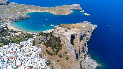 The Acropolis of Lindos in Rhodes island Greece. Saint Paul's Beach and Lindos Acropolis aerial panoramic view. - obrazy, fototapety, plakaty