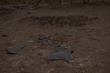 Kyiv, Ukraine - November 26, 2023: a crater in the ground and a destroyed playground