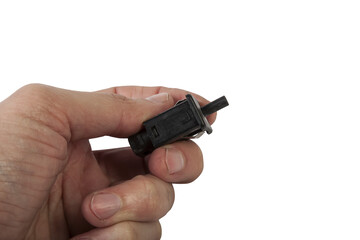 brake light switch in the hand under the brake pedal in a car on a white isolated background. catalog of spare parts for websites and advertising.
